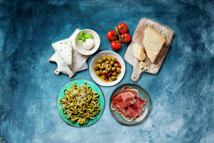 Antipasti: Various Types Of Cheese, Pickled Olives, Ham And Pasta Photograph by William Reavell