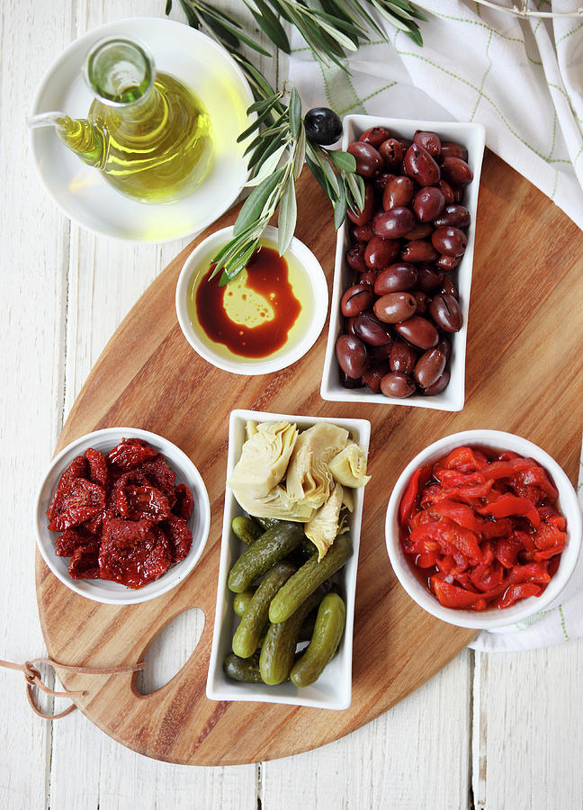 Antipasto Dish - Sun-dried Tomatoes And Capsicum, Kalamata Olives, Gherkins, Artichokes, Bread Rolls, Olive Oil with Balsamic Vinegarand Olive Branch Photograph by Trudy Kelder