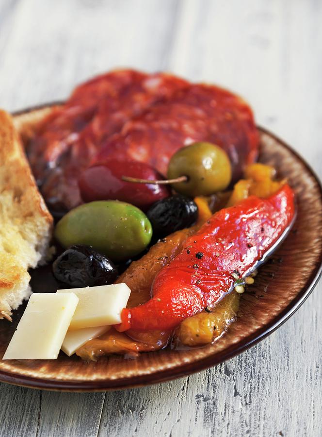 Antipasto With Fire Roasted Red And Yellow Peppers, Mixed Olives, Provolone Cheese, Sopressata And Italian Bread Photograph by Crudo, George