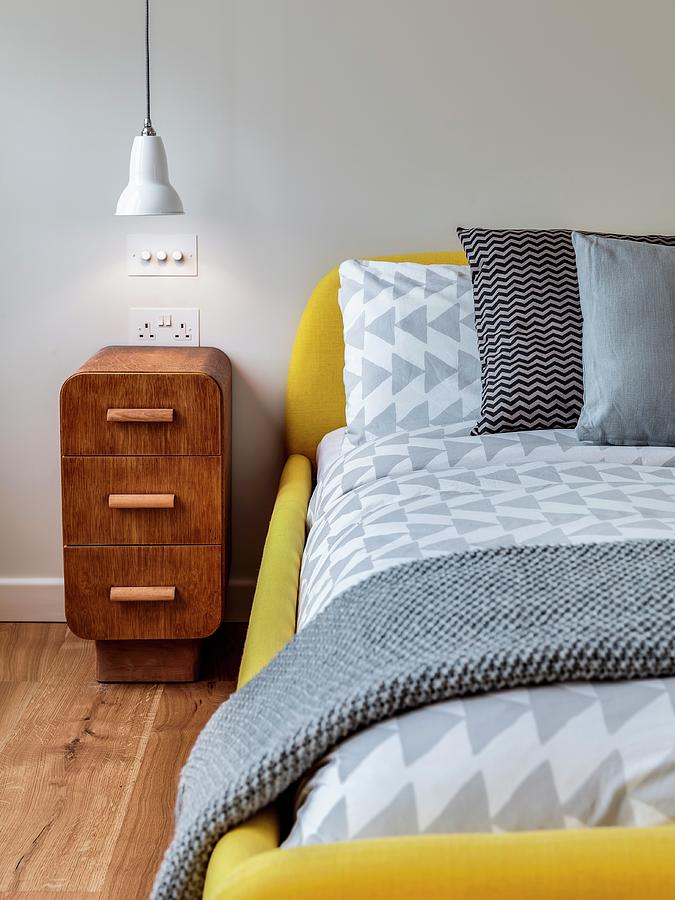 Antique Bedside Cabinet Next To Modern Bed With Yellow Upholstered Frame Photograph by Simon Maxwell Photography