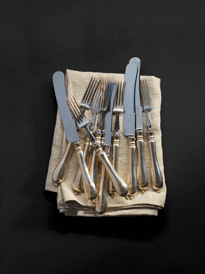 Antique Cutlery On A Fabric Napkin Photograph by Feig & Feig