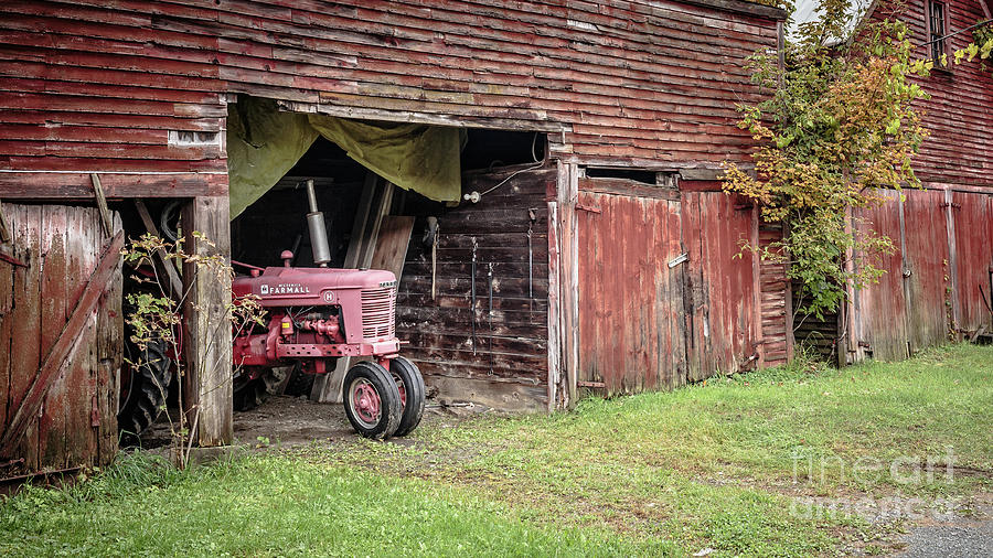 Antique Farmall Tractor Poking Out of the Old Barn Photograph by Edward Fielding