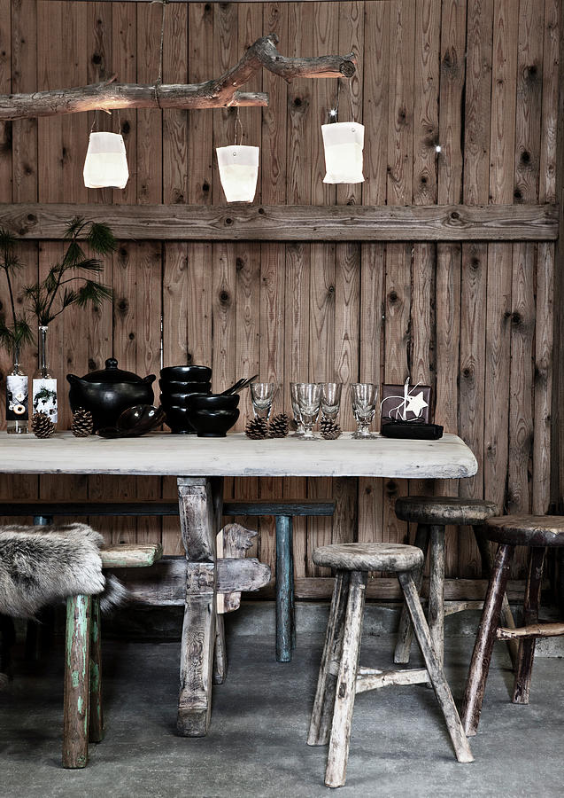 Antique Wine Glasses And Black Crockery On Table In Front Of Rustic Board Wall Photograph by Lykke Foged & Morten Holtum