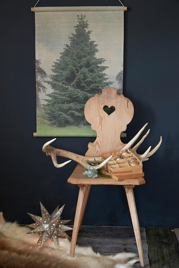 Antlers And Christmas Baubles On Farmhouse Chair Below Picture Of Tree Photograph by Inge Ofenstein