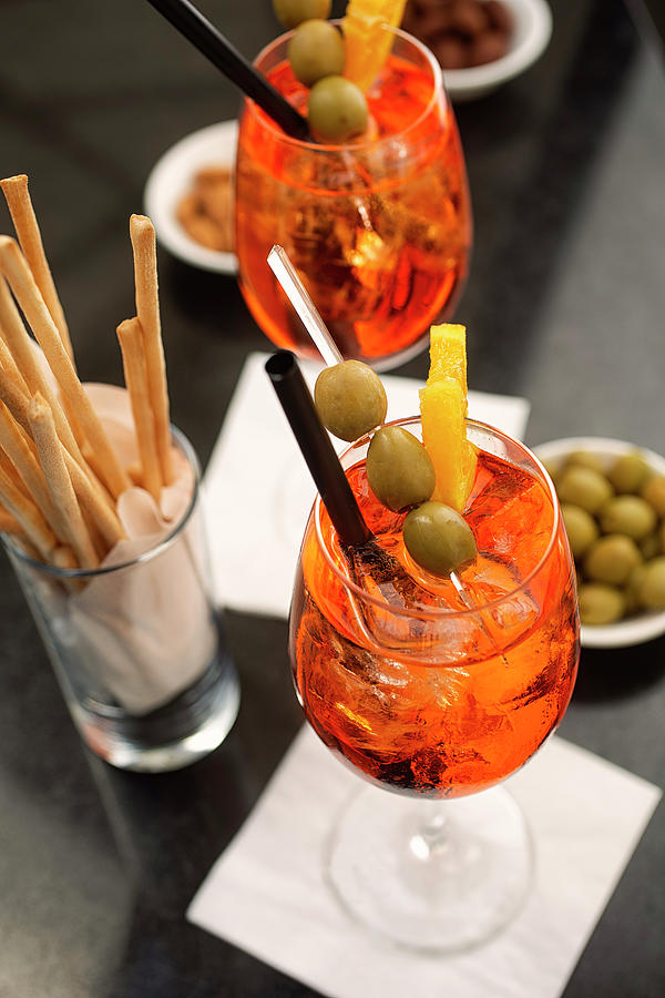 Aperitif With Aperol Spritz, Olives And Grissini Photograph by Herbert Lehmann