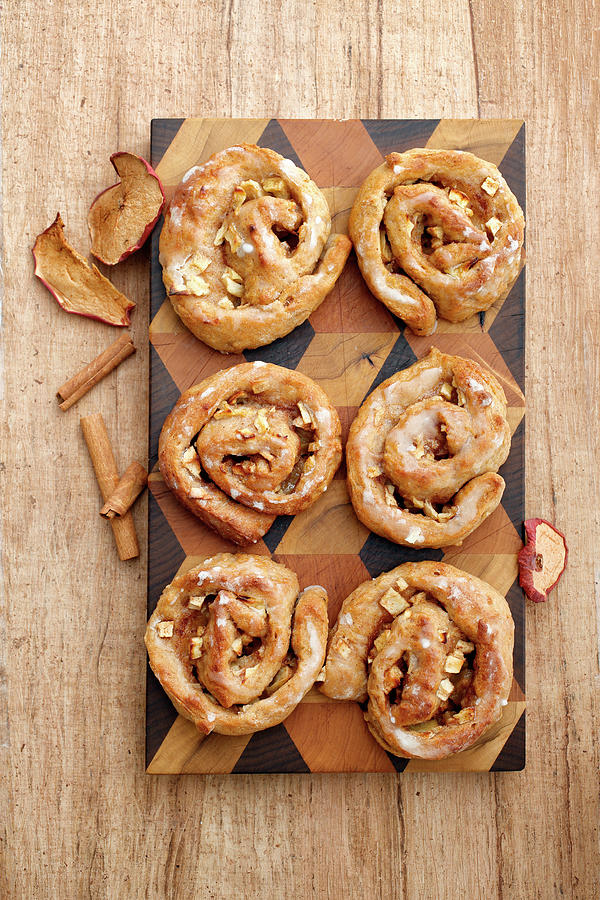 Apple And Cinnamon Buns On A Wooden Board seen From Above Photograph by Petr Gross