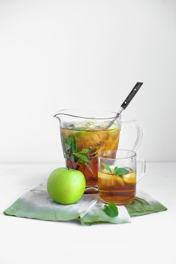 Apple And Mint Iced Tea In A Glass And In A Jug Photograph by Magdalena Hendey