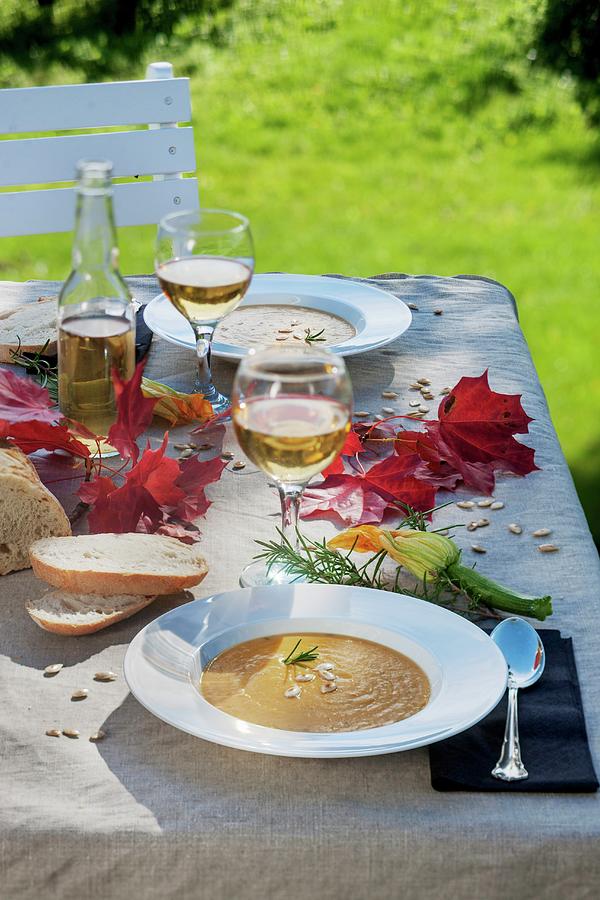 Apple And Pumpkin Soup Outside On An Autumnal Table Photograph by Per Magnus Persson