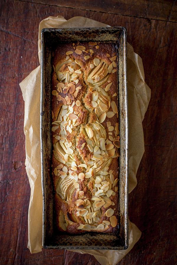 Apple Cake With Flaked Almonds In A Loaf Tin Photograph by Claudia Timmann
