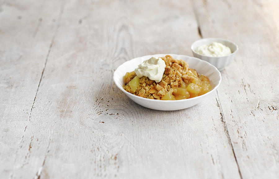 Apple Crumble With Calvados Served With Cream Photograph by Gareth Morgans