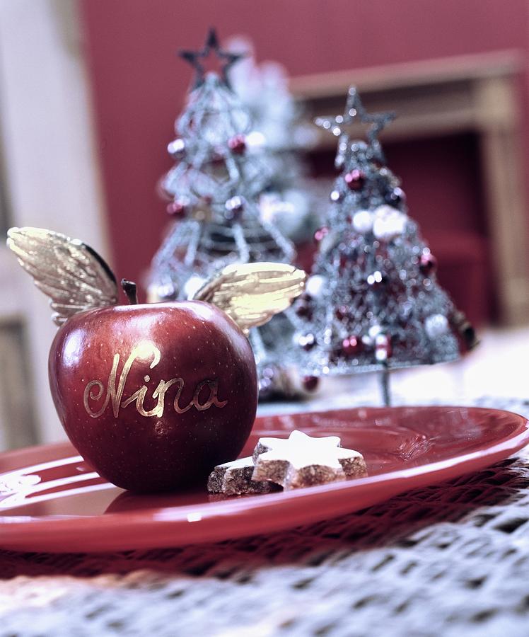 Apple, Festively Decorated With Angels Wings As Christmas Place Tag Photograph by Matteo Manduzio