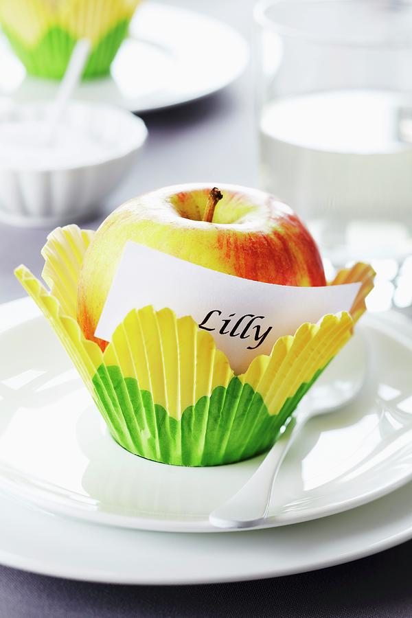 Apple In Paper Cake Case As Place Card Holder Photograph by Franziska Taube
