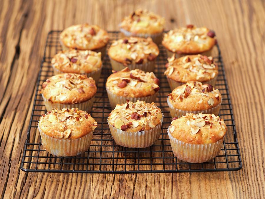 Apple Muffins With Hazelnuts On A Wire Rack Photograph by Rua Castilho