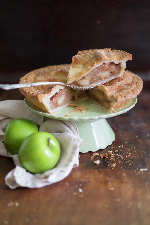 Apple Pie On A Cake Stand, And Fresh Green Apples Photograph by Eising Studio