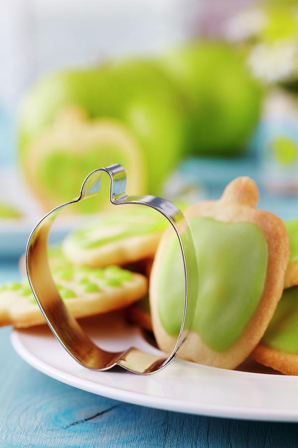 Apple-shaped Pastry Cutter On Plate Of Biscuits Photograph by Franziska Taube