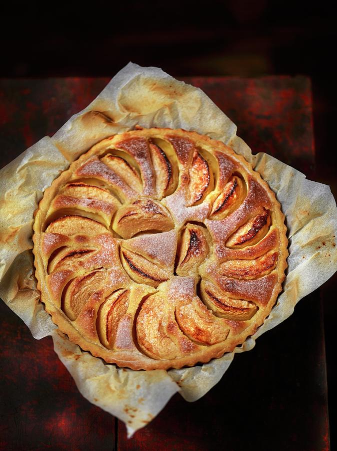 Apple Tart With Icing Sugar On A Piece Of Baking Paper Photograph by Frdric Perrin