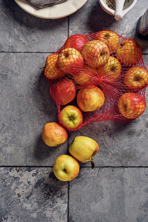 Apples In A Net Photograph by Angelika Grossmann