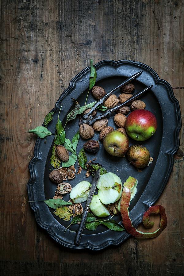 Apples, Walnuts, A Nutcracker And A Knife On A Tray Photograph by Elisabeth Von Plnitz-eisfeld