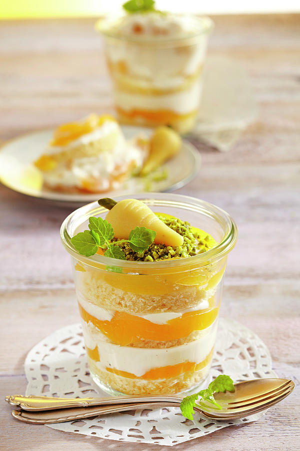 Apricot And Quark Layer Cake In A Jar Decorated With A Marzipan Carrot Photograph by Teubner Foodfoto