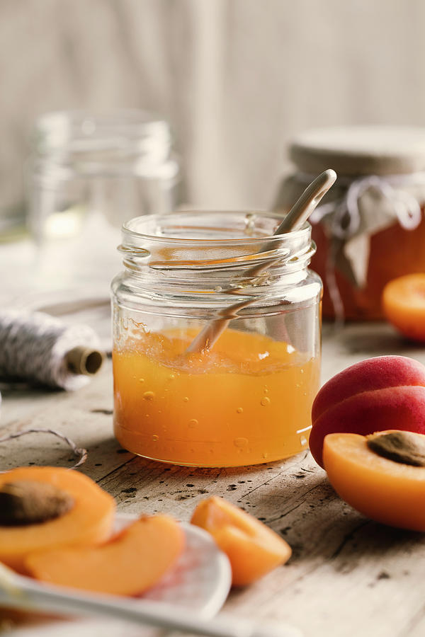 Apricot Jam In Jar With Spoon Photograph by Jennifer Braun
