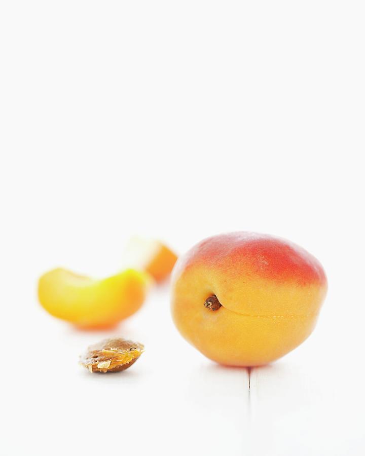 Apricots, An Apricot Wedge And An Apricot Stone Photograph by Jane Saunders