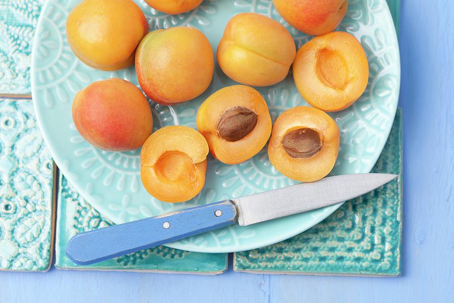 Apricots, Whole And Halved Photograph by Rua Castilho