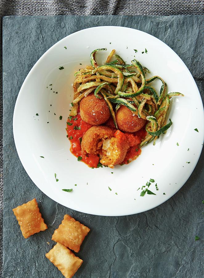 Arancini With Tomato Sauce And Courgettes Photograph by Robbert Koene