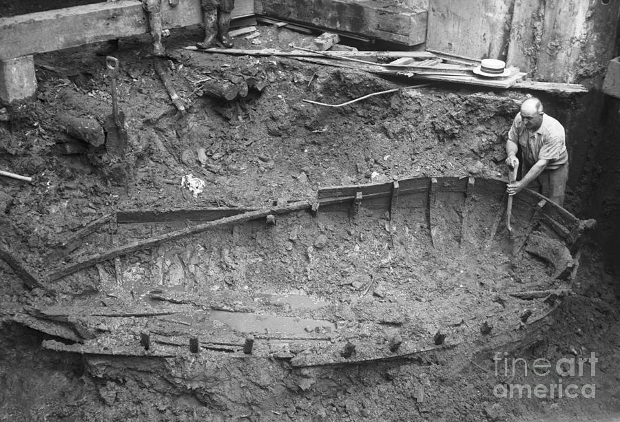 Archaeologist Digging Around Boat Photograph by Bettmann