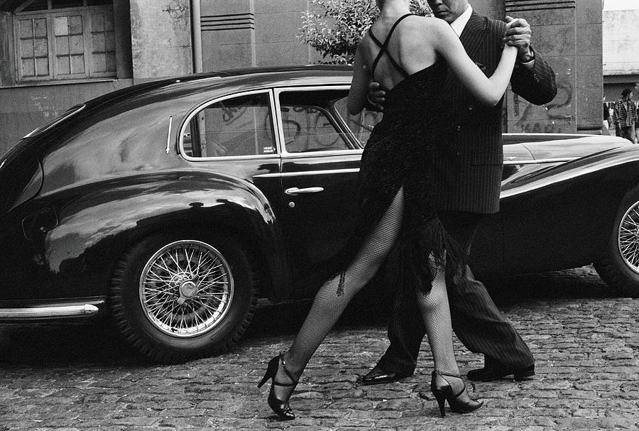 Argentina, Couple Dancing Tango By Car Photograph by Christopher Pillitz