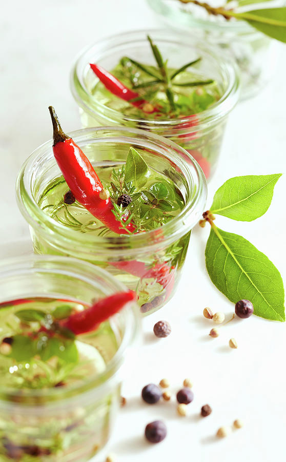 Aromatic Herb Oil With Fresh Red Chillis In Preserving Jars Photograph by Teubner Foodfoto