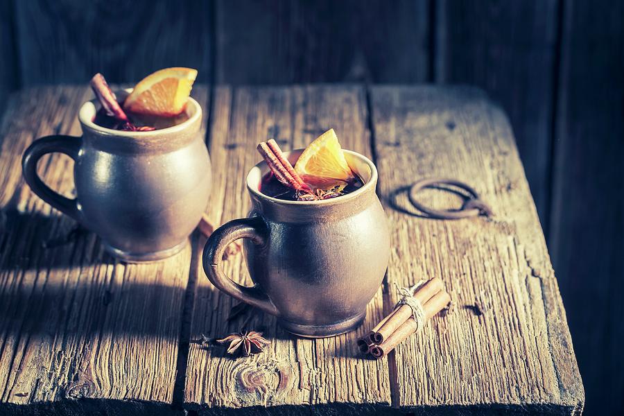 Aromatic Mulled Wine With Cinnamon And Star Anise On A Rustic Wooden Table Photograph by Shaiith