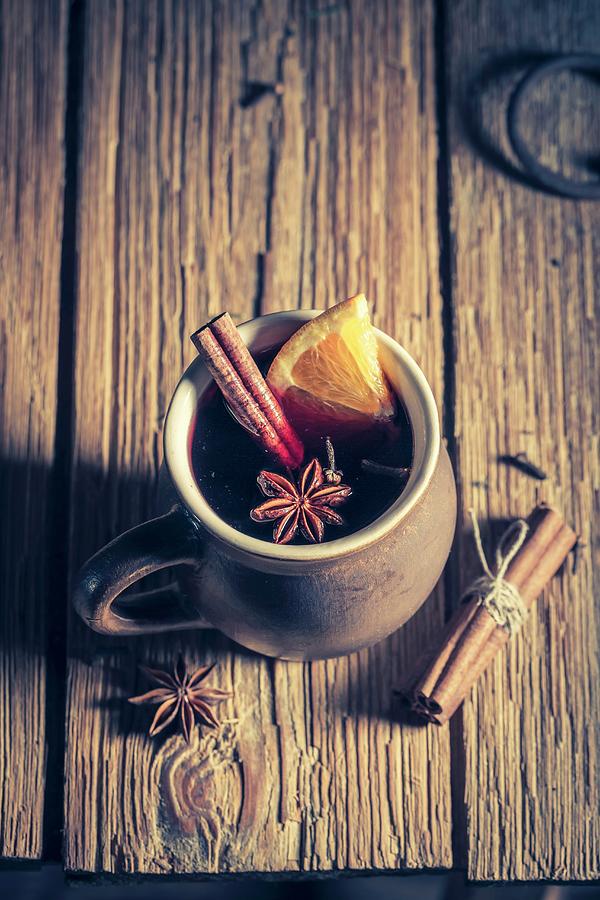 Aromatic Mulled Wine With Spices On A Rustic Wooden Table Photograph by Shaiith