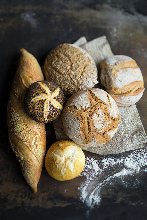 Arrangement Of Baguettes, Bread, Wholemeal Bread, A White Bread Roll And A Poppy Seed Roll Photograph by Katrin Winner