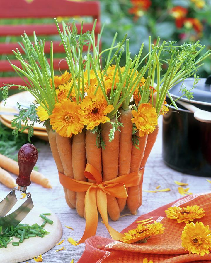 Arrangement Of Carrots And Marigolds Photograph by Friedrich Strauss