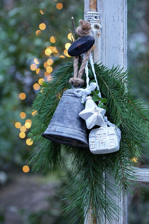 Arrangement Of Fir Branches, Bell, Star And Small House Hung From Window Handle Photograph by Angelica Linnhoff
