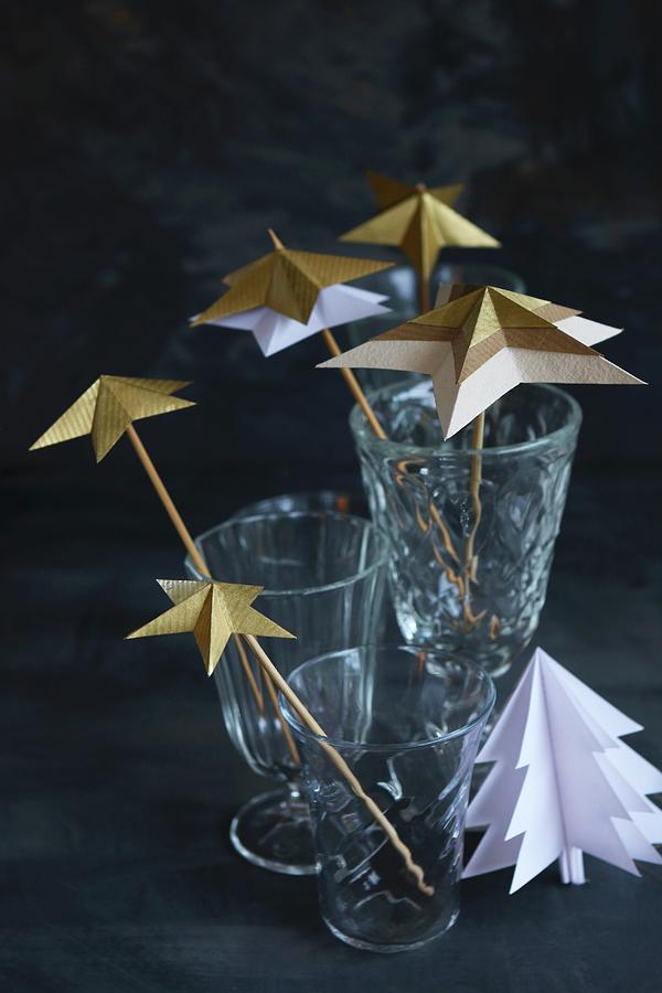 Arrangement Of Paper Stars Threaded On Rods In Glasses On Table Photograph by Regina Hippel