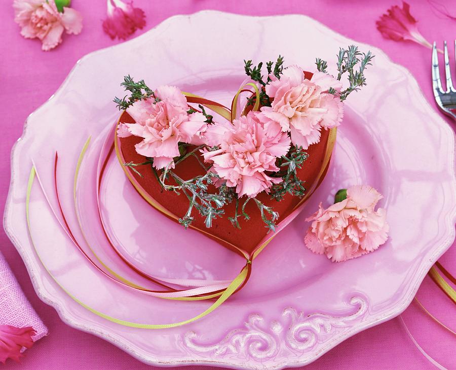 Arrangement Of Pink Carnations And Rosemary In A Red Heart Photograph by Strauss, Friedrich