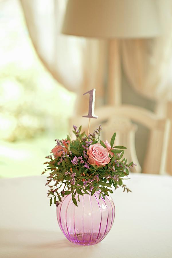 Arrangement Of Roses And Table Number In Spherical Glass Vase Photograph by Elizaveta Dogadaeva