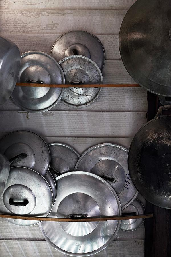 Arrangement Of Shiny Pot Lids And Rusty Pots Photograph by Ulf Svane