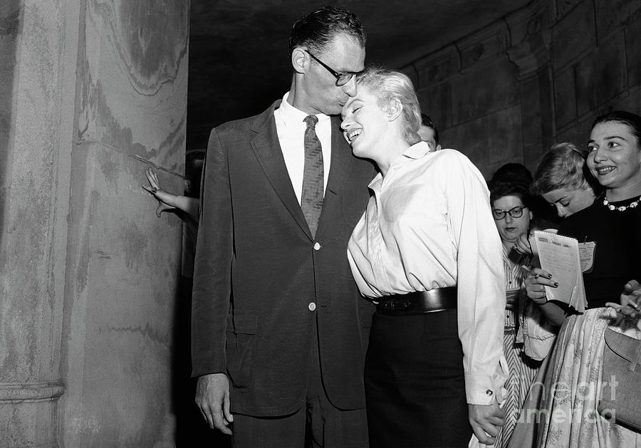 Arthur Miller Kissing Marilyn Monroe Photograph by Bettmann