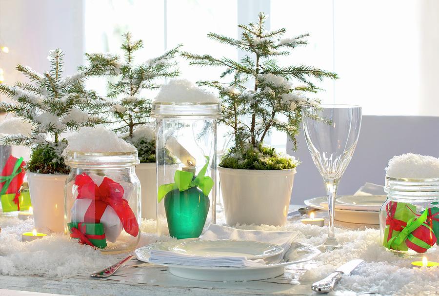 Artificial Snow, Small Fir Trees And Wrapped Gifts In Mason Jars On Christmas Table Photograph by Angela Francisca Endress