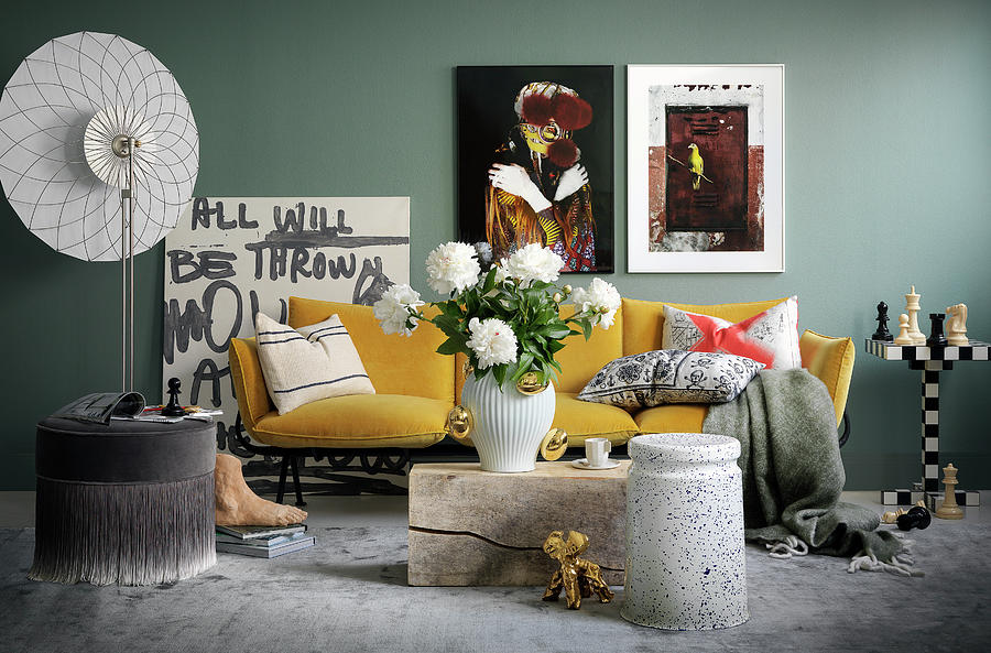 Artworks And Yellow Sofa Against Grey Wall In Living Room Photograph by Anderson Karl