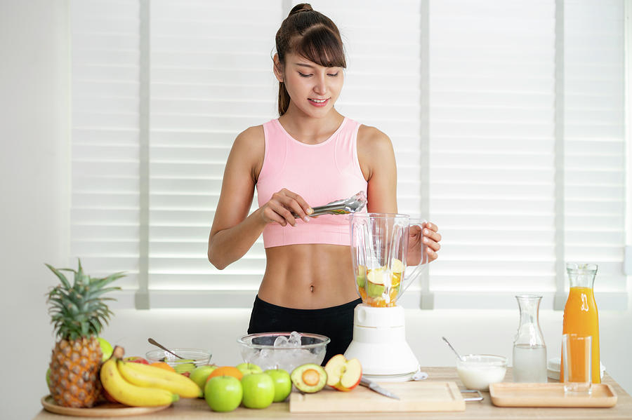 Asian girl prepare material for make a smoothie juice Photograph by ...