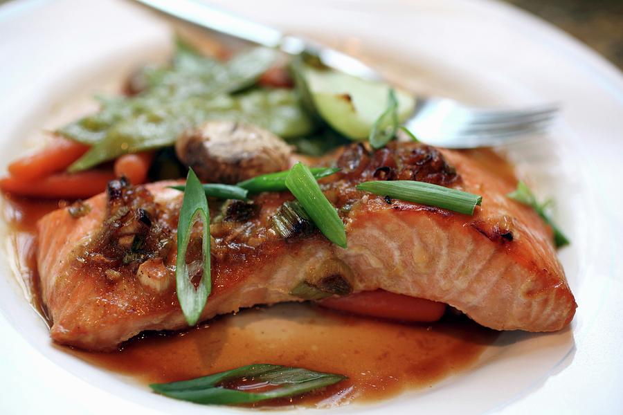 Asian-marinated Salmon With Steamed Vegeatables And Chopped Scallion Garnish Photograph by Doug Schneider Photography
