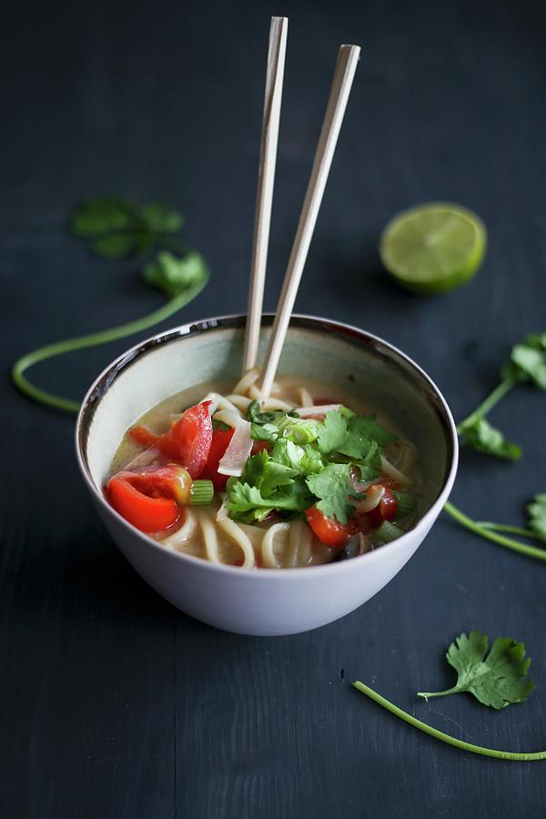 Asian Noodle Soup With Lime, Coriander And Chopsticks Photograph by Eva Lambooij