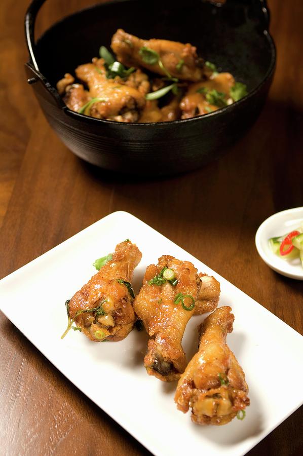Asian Style Chicken Drumettes On A Platter; Chicken In Bowl In ...
