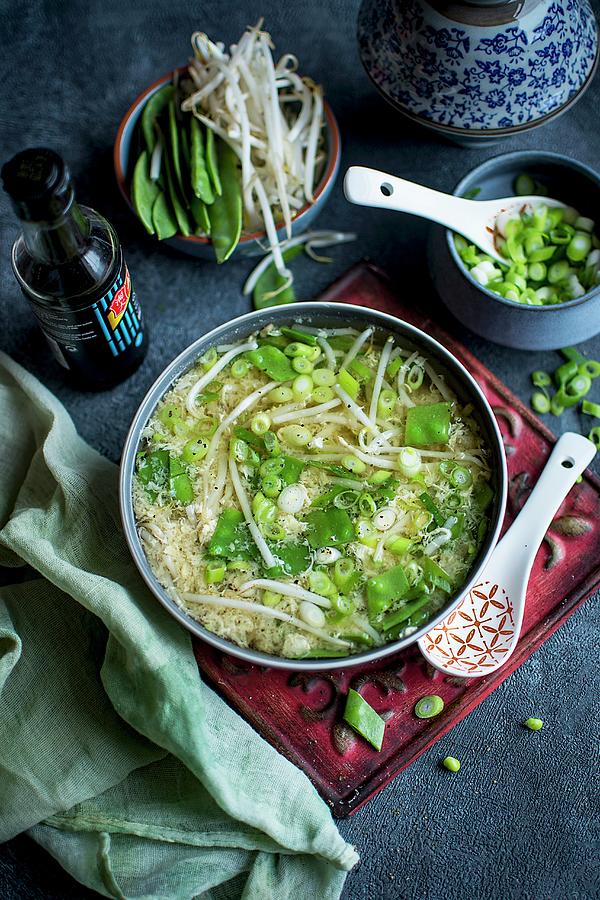 Asian-style Egg Soup With Peas, Sprouts, Spring Onion And Soy Sauce Photograph by Olimpia Davies