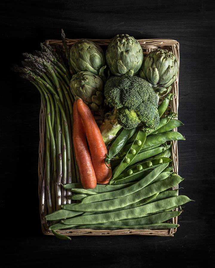 Asparagus, Carrots, Artichokes, Broccoli, Peas And Broad Beans In A Basket Photograph by Miriam Garcia