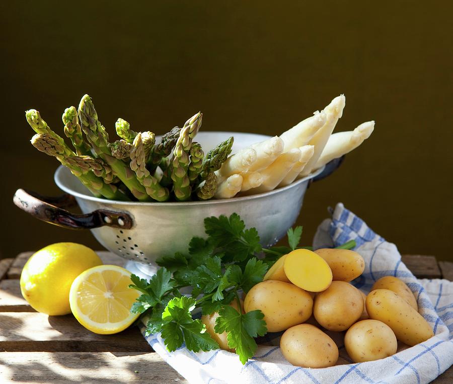 Asparagus In A Sieve With Lemons, Parsley And Potatoes Photograph by Foodografix