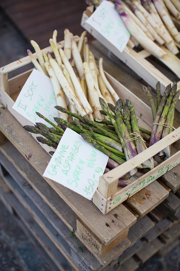 Asparagus In Crates At The Torvehallerne Market In Copenhagen Photograph by Anne Faber